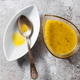 Vinaigrette in a ceramic dish on a concrete tabletop